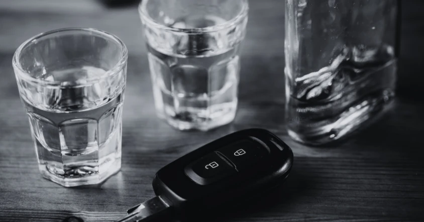 Summer DWI enforcement in College Station with alcohol glasses and car keys